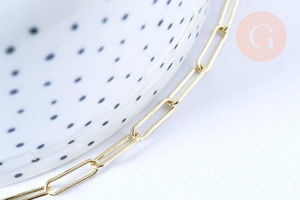Gold-tone rectangular chain necklace on a white ceramic dish with black polka-dots, featuring 12x3.5mm links, from Gingerlily's jewelry collection.