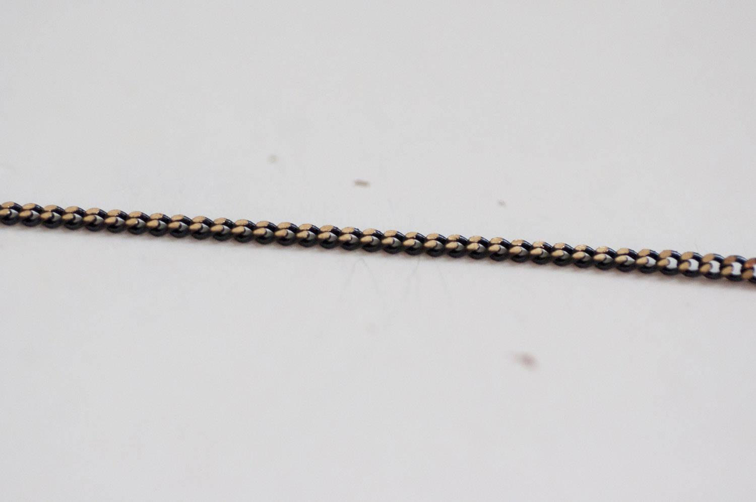 EP-Chaine fine maille plate noire reflets dorés 1.5mm, X 5 mètres G0554