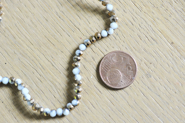 EP Perles toupies cristal blanc doré 4x3mm, x1 fil de 120