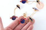Broche pins double planète éclair doré émail ,broche dorée ,décoration veste,x1 G6381