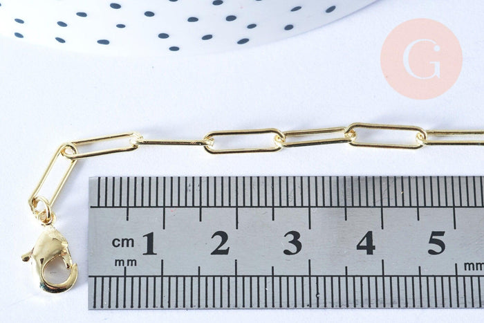 Gold-tone rectangular link chain with lobster-claw clasp, 46.5cm long, displayed with a ruler for scale, part of Collier Chaine laiton doré clair collection.