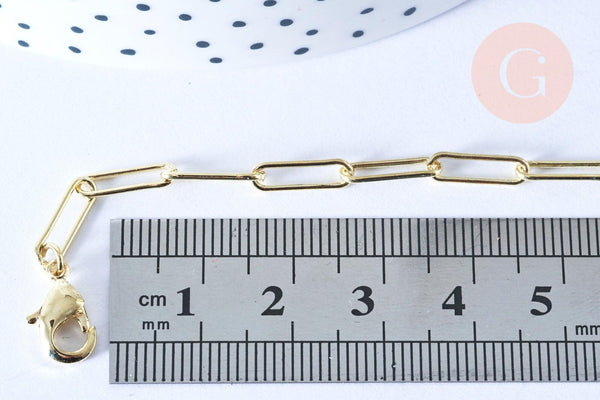 Gold-tone rectangular link chain with lobster-claw clasp, 46.5cm long, displayed with a ruler for scale, part of Collier Chaine laiton doré clair collection.