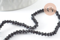 Perles cristal toupies à facette noir 2x3mm, x1 fil de 49cm (G4670)
